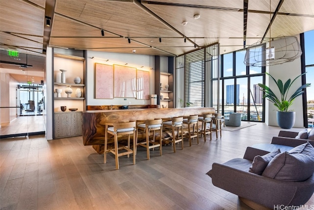 dining room featuring wooden ceiling, wood finished floors, and expansive windows