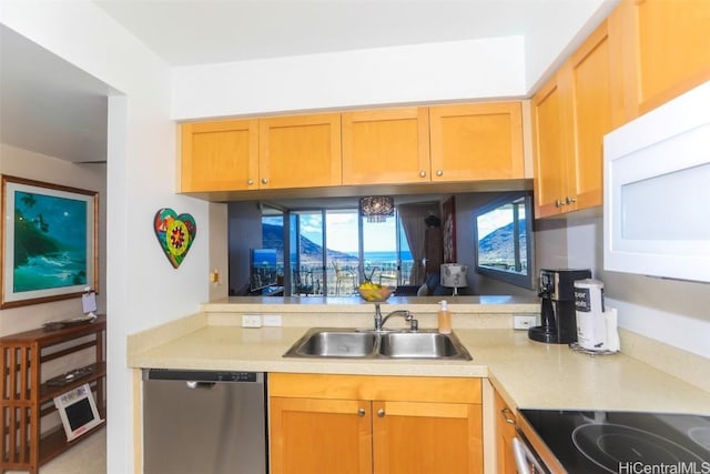 kitchen with light countertops, stainless steel dishwasher, white microwave, a sink, and range