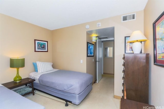 bedroom featuring light colored carpet and visible vents