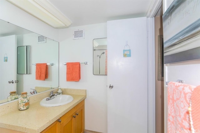 bathroom with vanity and visible vents