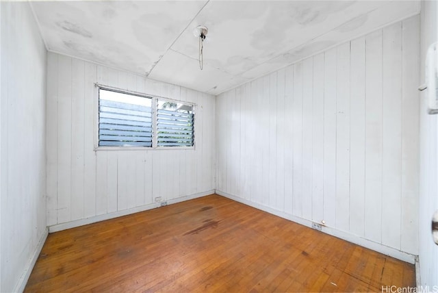 unfurnished room with wood-type flooring