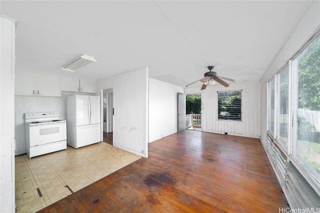 kitchen with white appliances, plenty of natural light, ceiling fan, and tile patterned floors