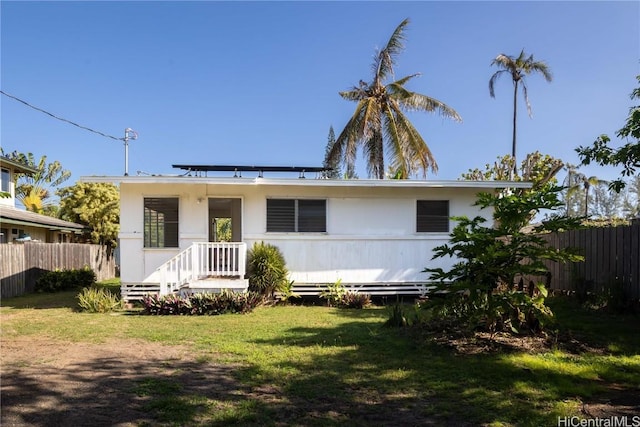 view of front of home featuring fence and a front yard