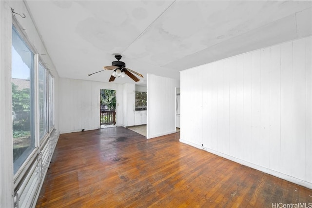 empty room with ceiling fan and hardwood / wood-style floors