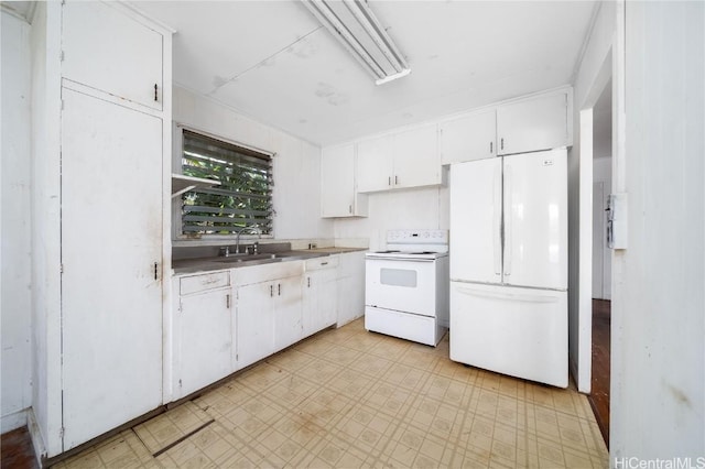 kitchen with a sink, white appliances, white cabinetry, and light floors