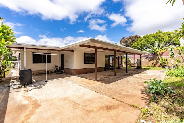 exterior space with a carport and concrete driveway