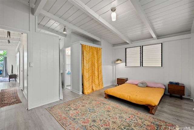 bedroom featuring vaulted ceiling with beams, wooden ceiling, and wood finished floors