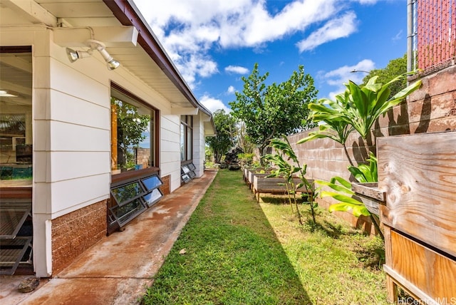 view of yard with a vegetable garden and fence