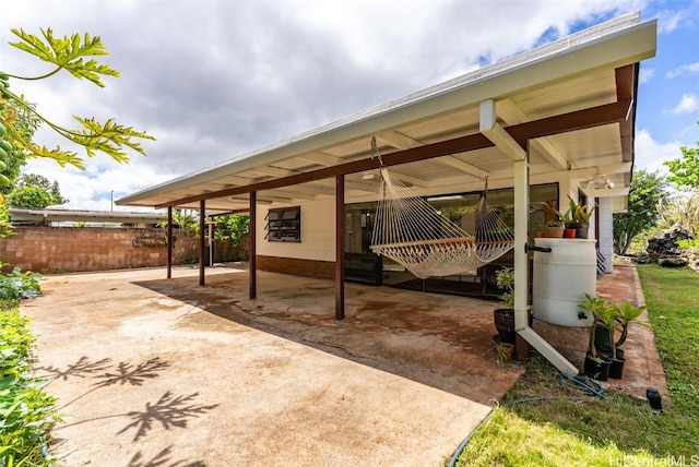 view of patio / terrace with fence and a carport