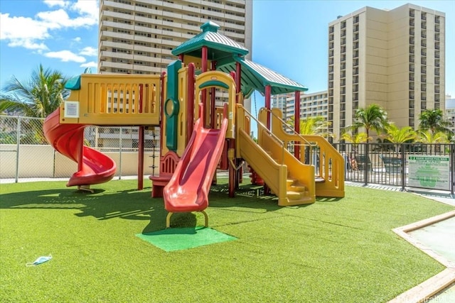 community playground with a yard and fence