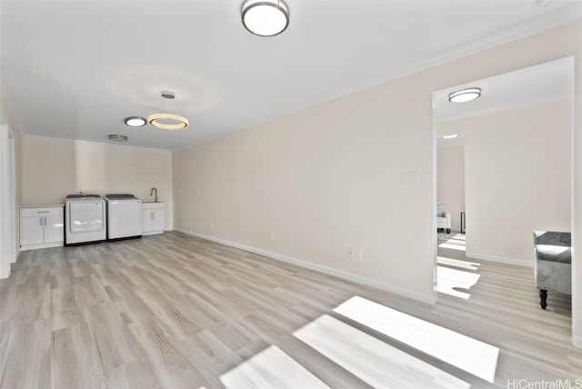 interior space with light wood-style flooring, ornamental molding, baseboards, and independent washer and dryer