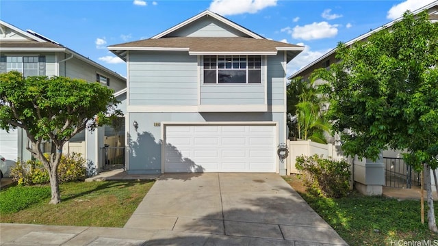 view of front of house featuring a garage, driveway, fence, and stucco siding