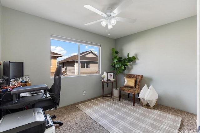 office space with a ceiling fan and carpet