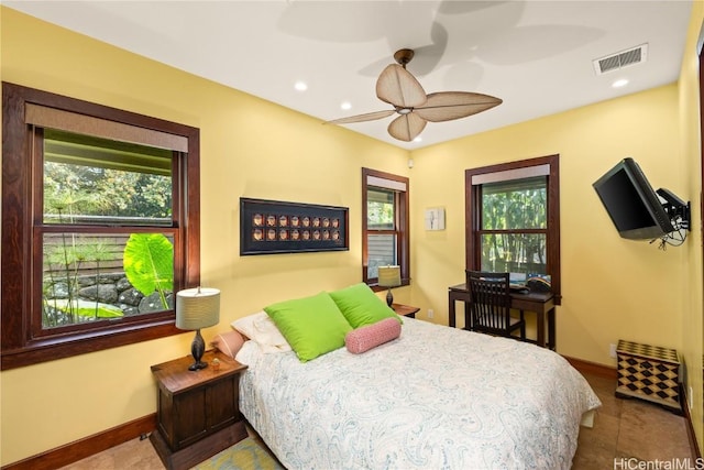 bedroom with baseboards, multiple windows, visible vents, and recessed lighting