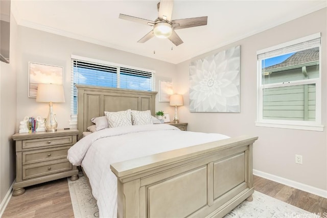 bedroom featuring light wood-style floors, baseboards, and ornamental molding