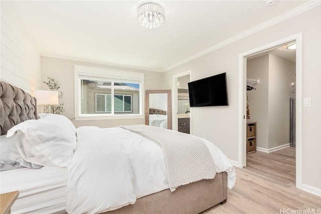 bedroom with light wood-style flooring, ensuite bath, baseboards, and ornamental molding