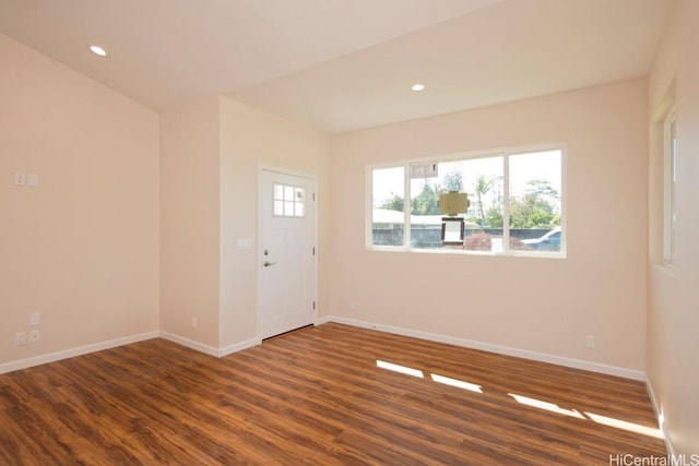 empty room featuring recessed lighting, wood finished floors, and baseboards