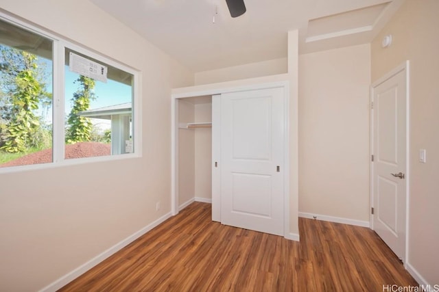 unfurnished bedroom featuring ceiling fan, a closet, wood finished floors, and baseboards