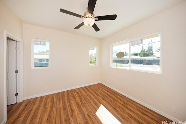 unfurnished room with baseboards and wood finished floors