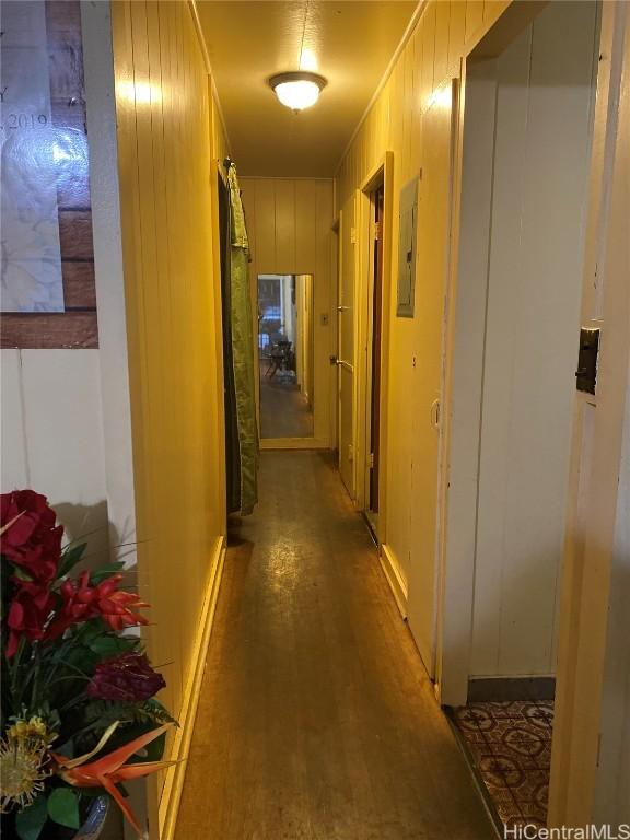 corridor featuring wood walls and wood finished floors