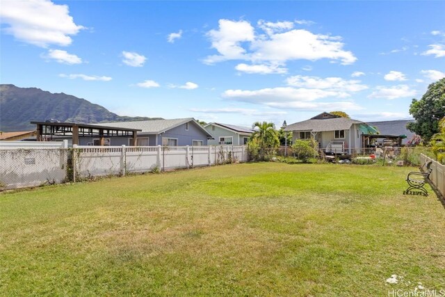 view of yard featuring a fenced backyard and a mountain view