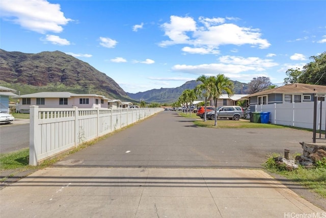 view of road with a residential view and a mountain view