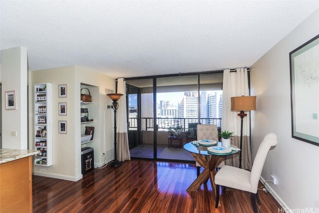 dining room with a textured ceiling, floor to ceiling windows, dark wood-type flooring, and baseboards