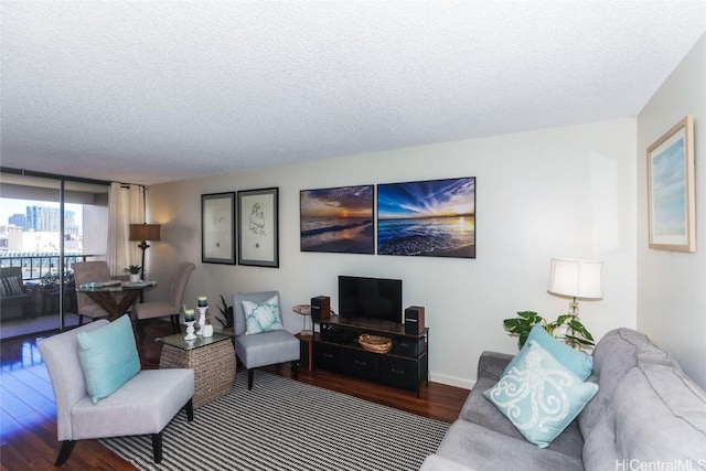 living room with a textured ceiling, baseboards, wood finished floors, and floor to ceiling windows