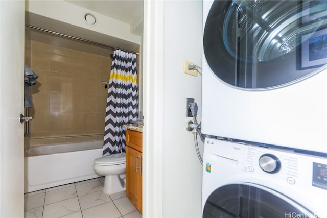 bathroom with toilet, stacked washer and dryer, shower / bath combo with shower curtain, and vanity