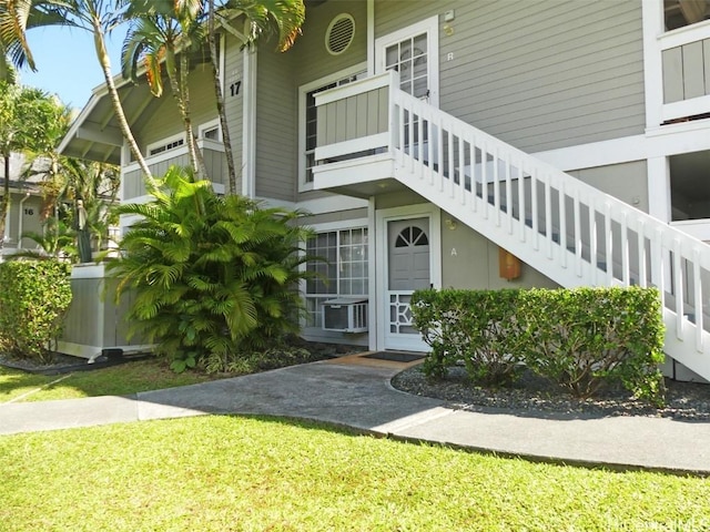 view of side of property featuring stairs