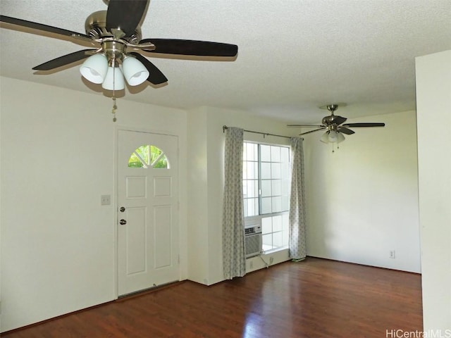 foyer with a textured ceiling and wood finished floors