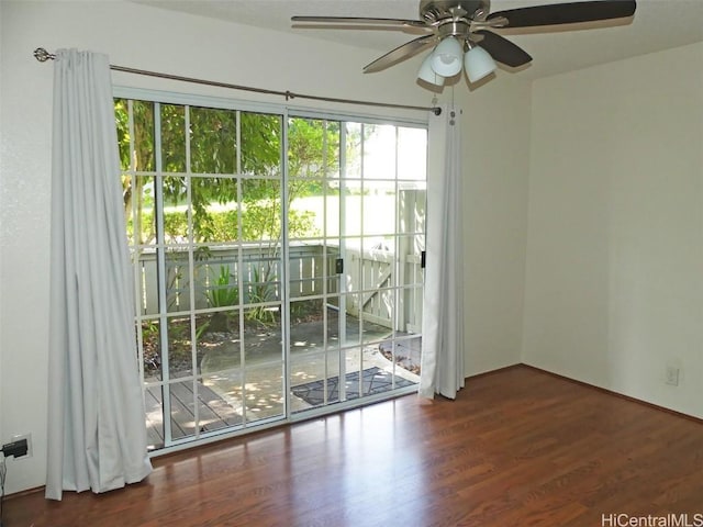 spare room with wood finished floors and a ceiling fan