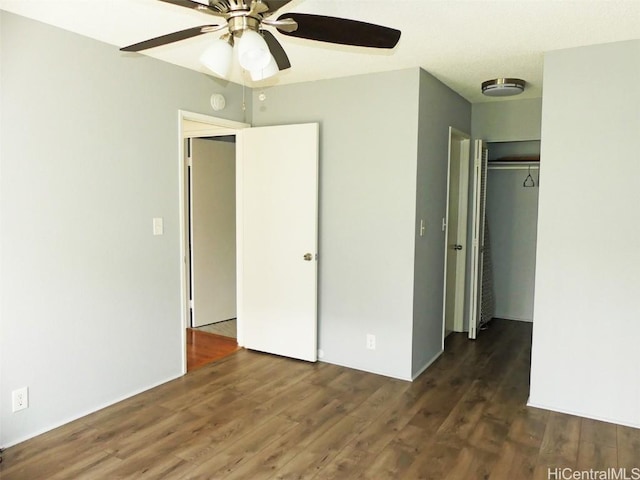 unfurnished bedroom featuring ceiling fan, a closet, and wood finished floors