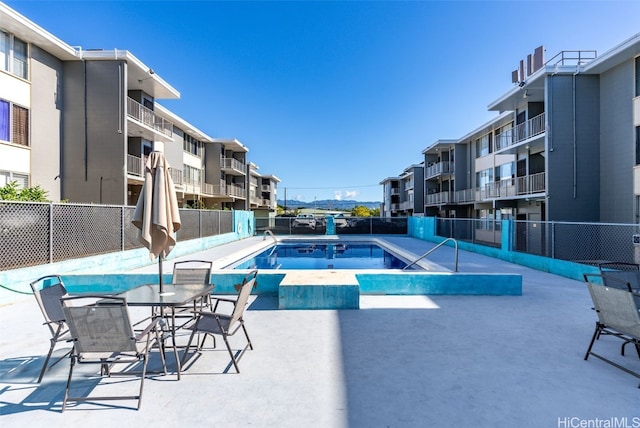 pool featuring a patio area and fence