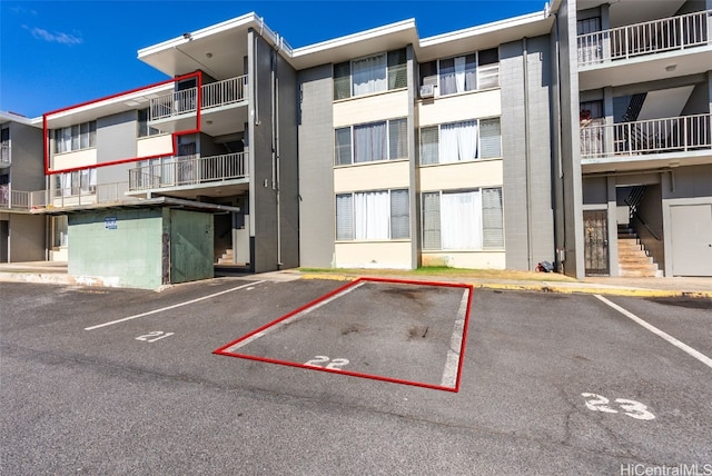 view of property featuring uncovered parking