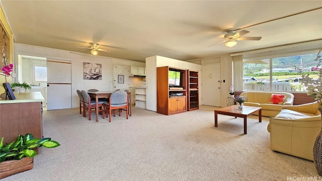 living room with light colored carpet and ceiling fan