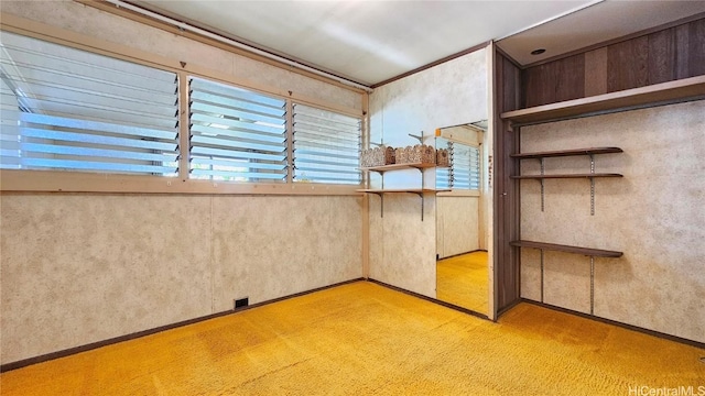 unfurnished bedroom with carpet floors and crown molding