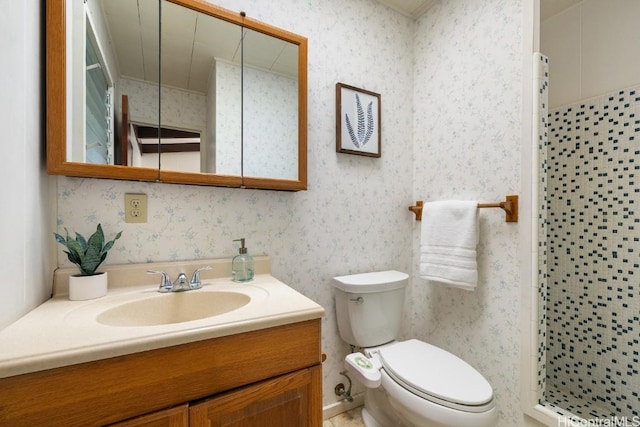 full bathroom featuring toilet, a stall shower, vanity, and wallpapered walls