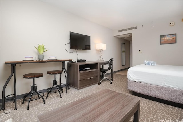 bedroom with carpet floors, baseboards, and visible vents