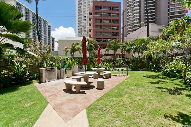 view of community featuring a yard and a patio area