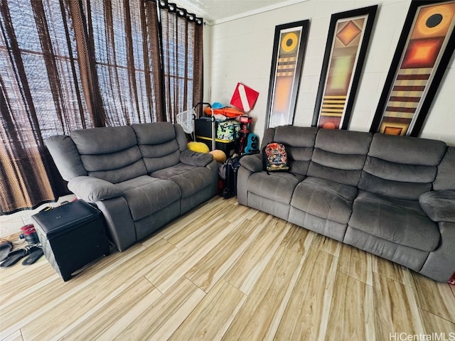 living room with concrete block wall and wood finished floors