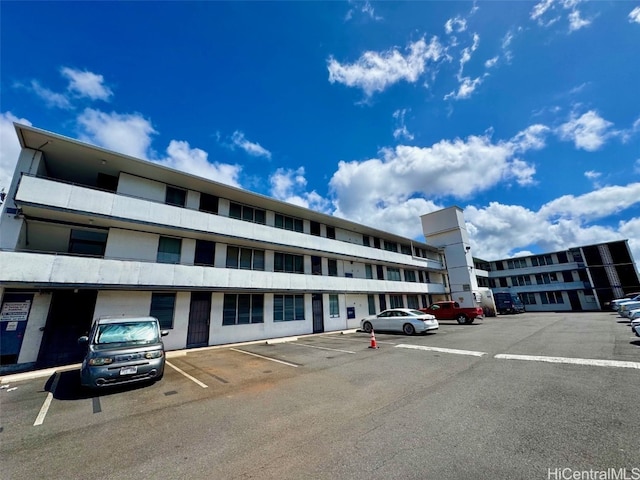 view of property featuring uncovered parking