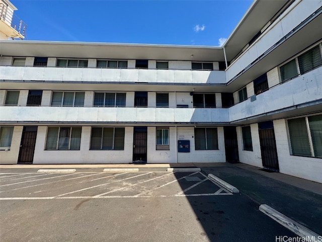 view of building exterior featuring uncovered parking