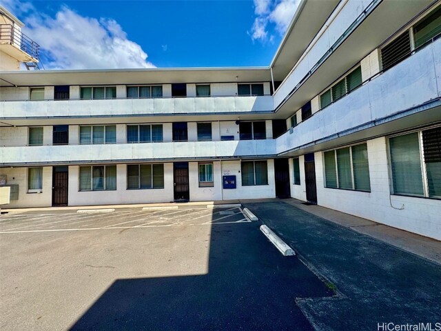 view of property featuring uncovered parking