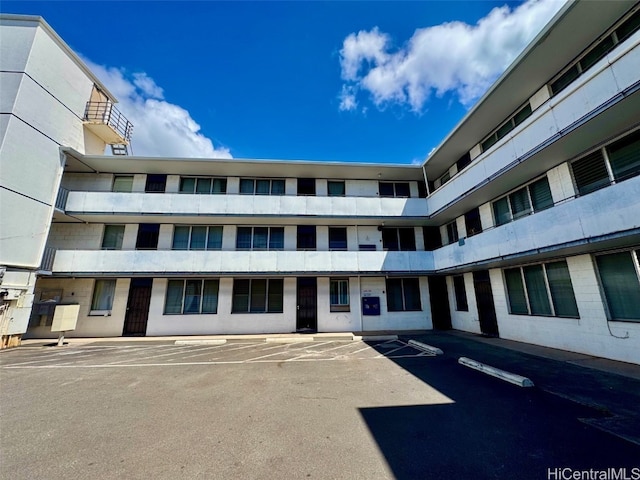 view of property featuring uncovered parking