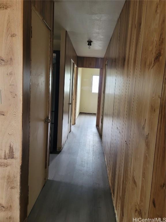 hallway with wood walls