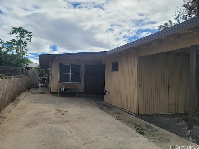 view of side of property featuring fence