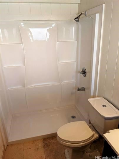 bathroom with vanity, walk in shower, toilet, and tile patterned floors