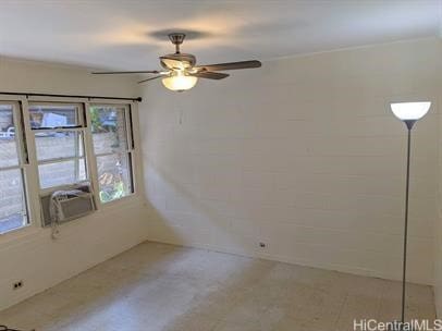 spare room featuring ceiling fan and cooling unit