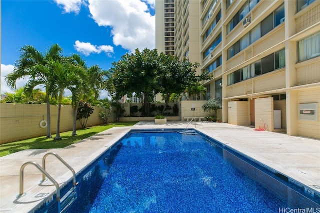 pool with a patio and a fenced backyard